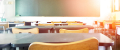 An empty classroom of desks and chairs