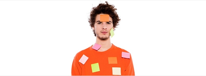 A boy covered in sticky notes