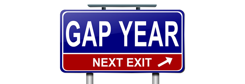 A sign with the words "GAP YEAR - NEXT EXIT"